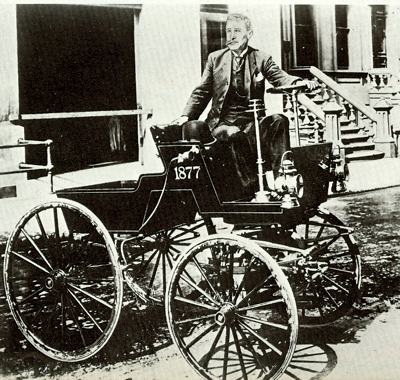 George SeIden poses in his three-cylinder tourer of 1877